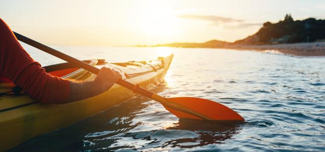 Close Up of Man Holding Kayak Paddles